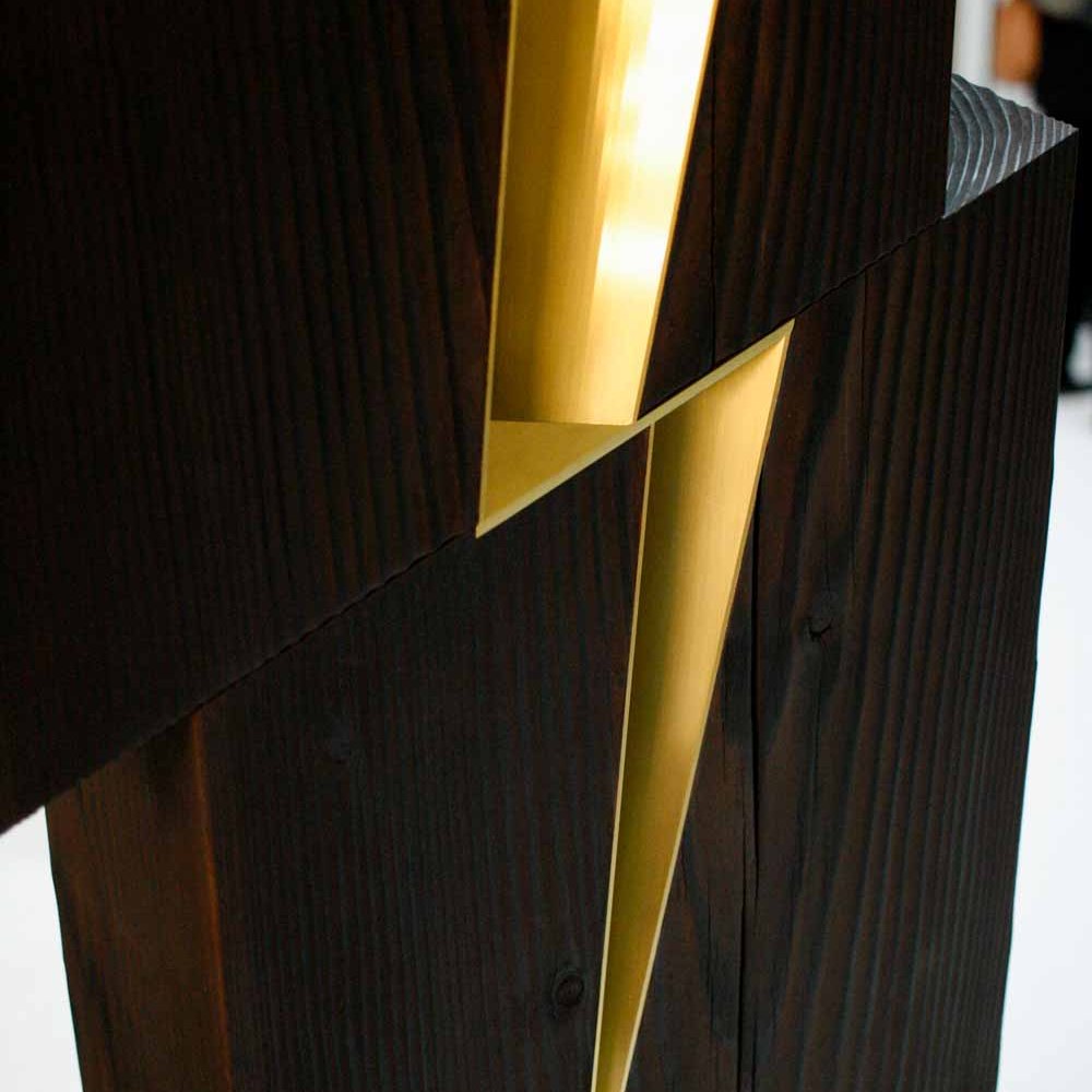 Wood sculpture with brass inlay