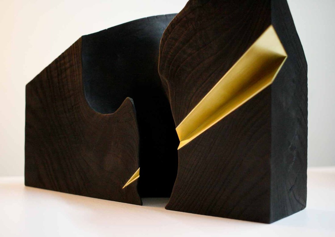 Wood sculpture with brass inlay
