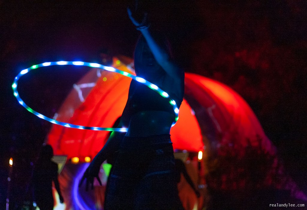 Girl dancing with electric hula hoop at night
