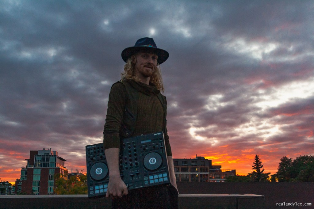 Jesse Buck holding a mixer atop a Toronto rooftop at sunset. © Andy Lee, realandylee.com