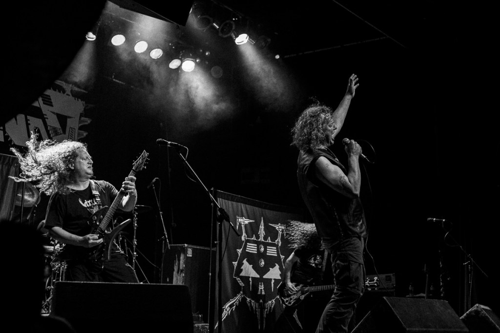 Black-and-white concert photo of heavy metal band