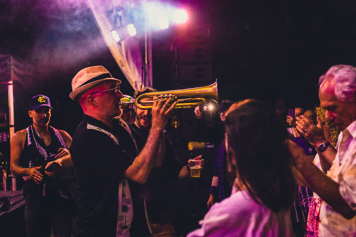 A man plays trumpet directly in front of a crowd at the Toronto Jazz Festival. © Andy Lee, 2022. realandylee.com
