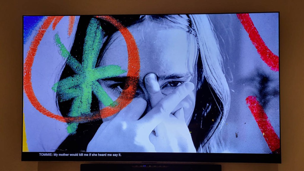 Woman crossing middle fingers over her face