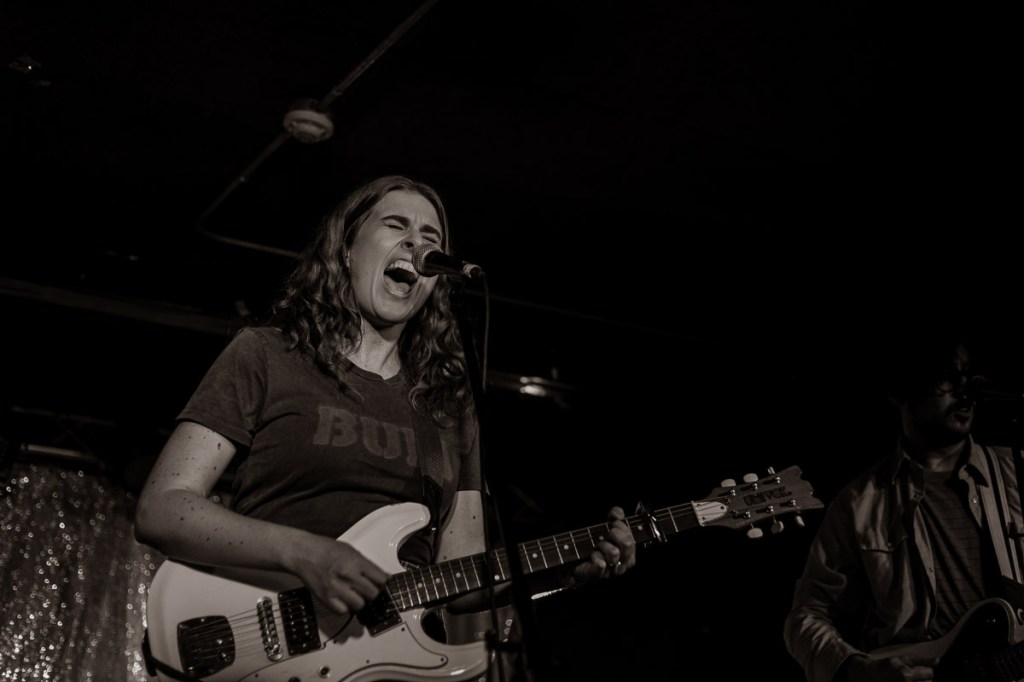 Elodie Tomlinson singing and playing guitar at The Garrison in Toronto