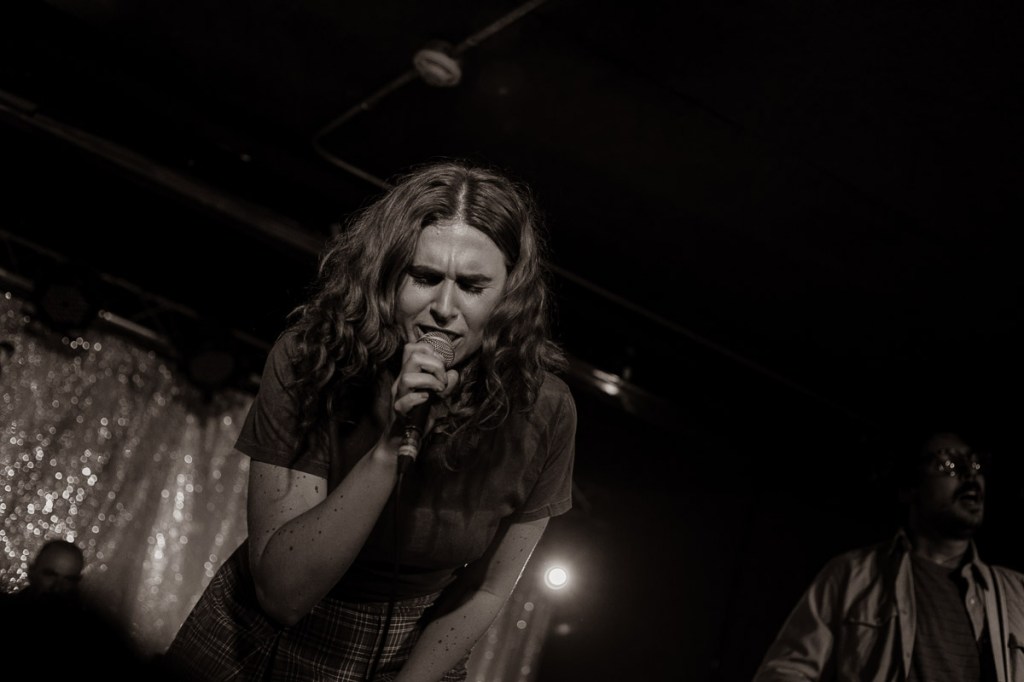 Elodie Tomlinson singing and playing guitar at The Garrison in Toronto