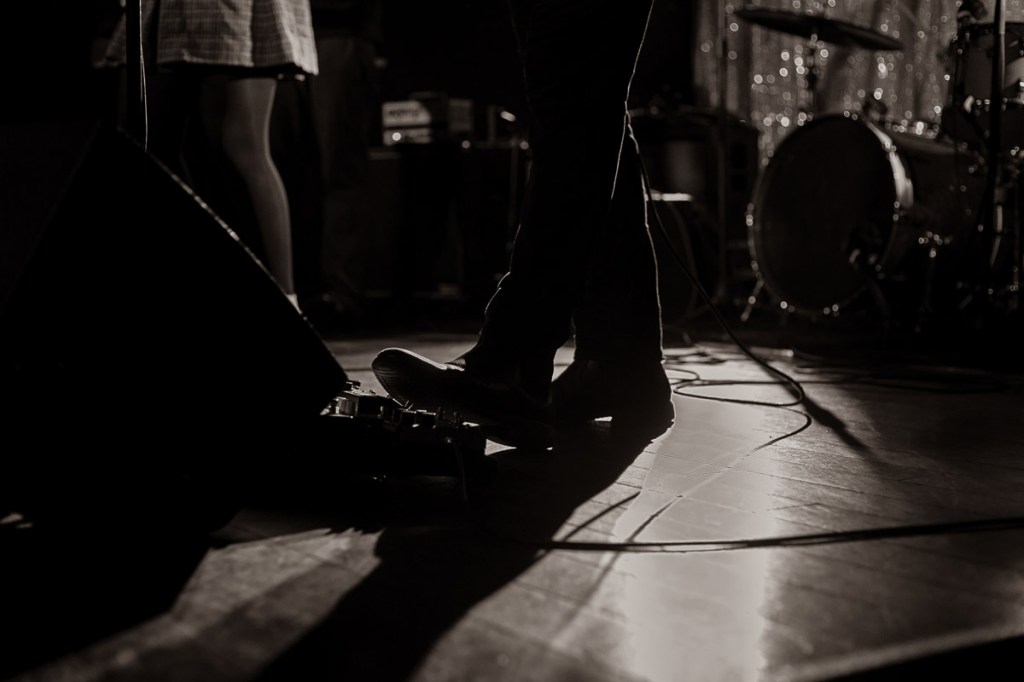 Band members' legs on stage at The Garrison in Toronto
