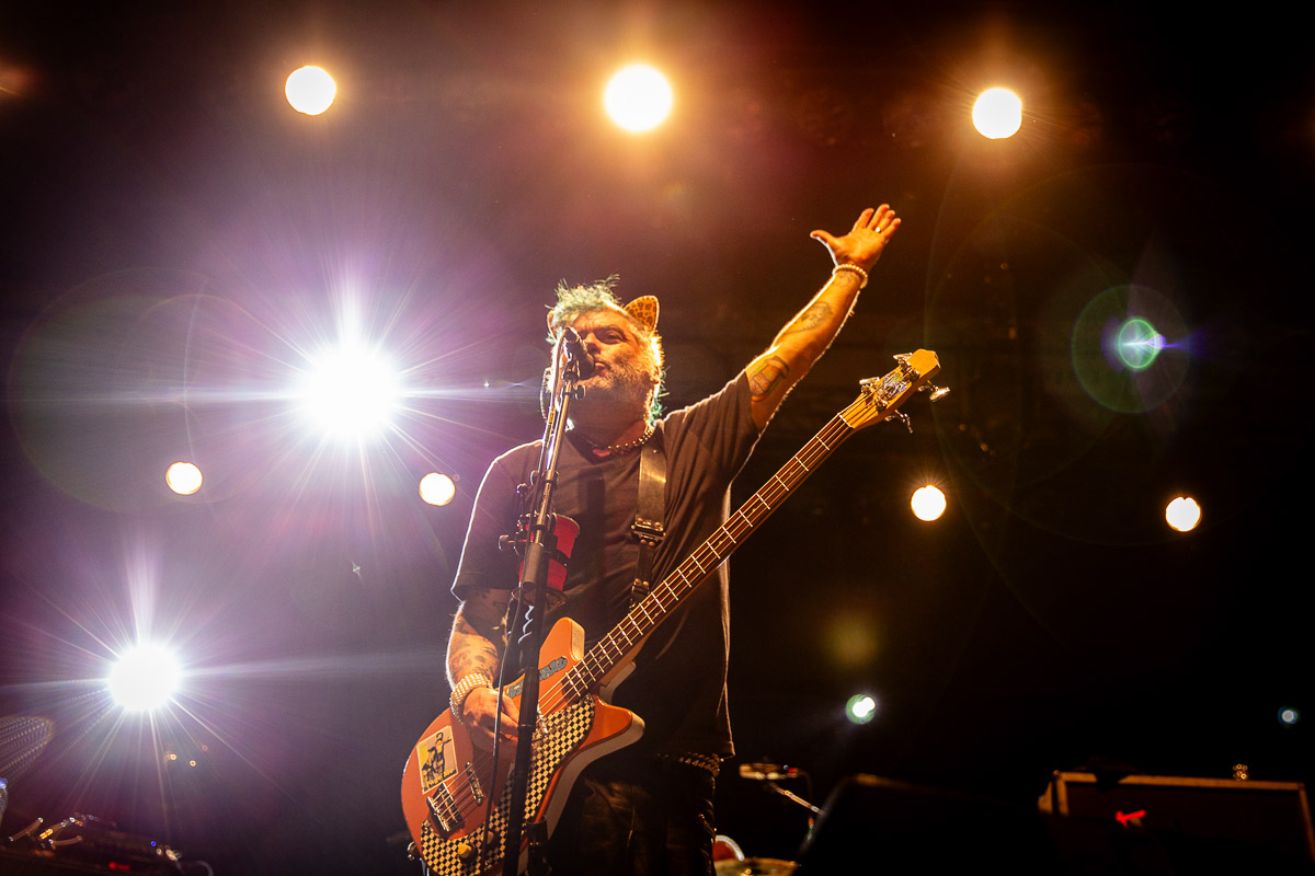 Fat Mike raising his left hand onstage