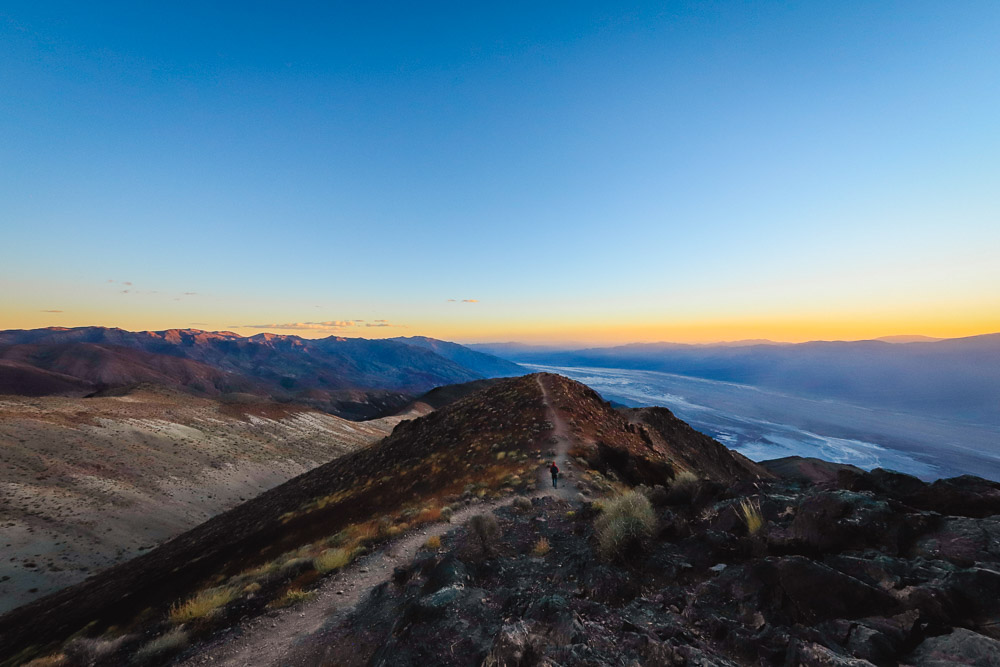 A lone hiker takes in panoramic Dante’s View at sunset