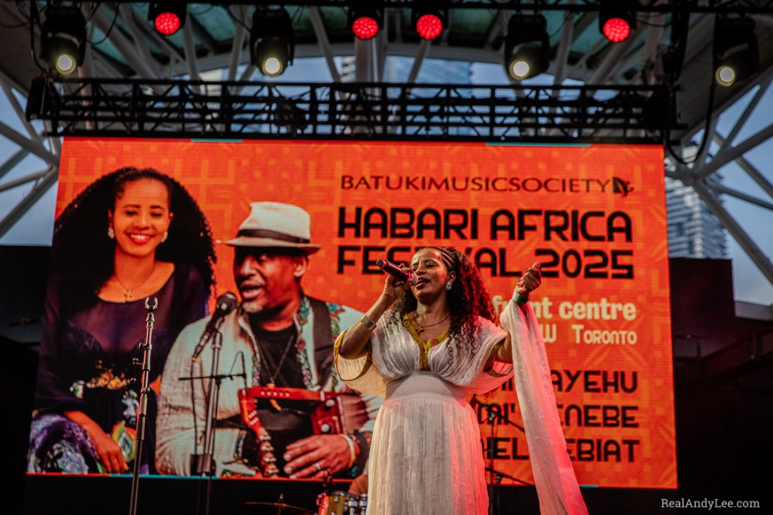 Ethiopian female singer onstage in a white traditional dress